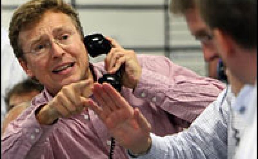 Brokers in London react to news of a half-percentage-point rate cut from the Bank of England on Wednesday.