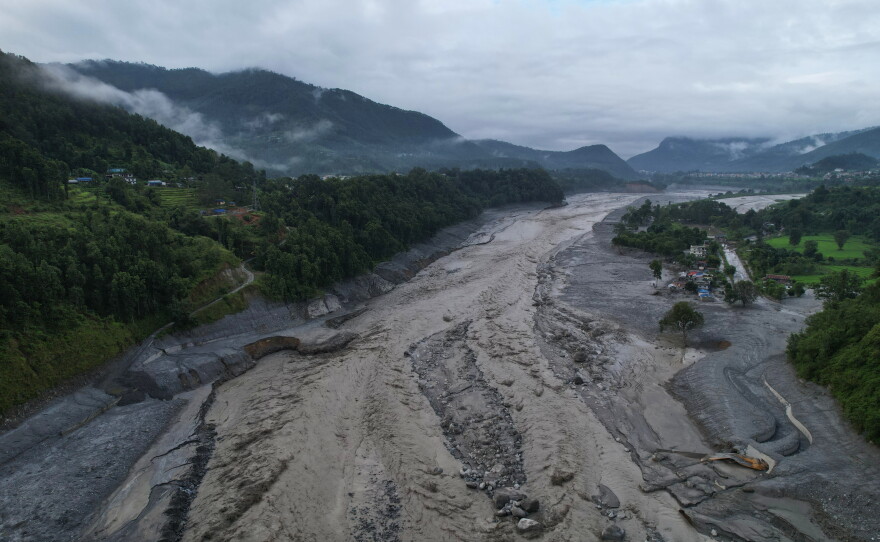 A drone view shows a major section of Pasang Lhamu highway washed away along swollen Trishuli river by recent flash floods cutting off Rasuwa district from Nuwakot area, Nepal, Monday, Aug. 31, 2026.