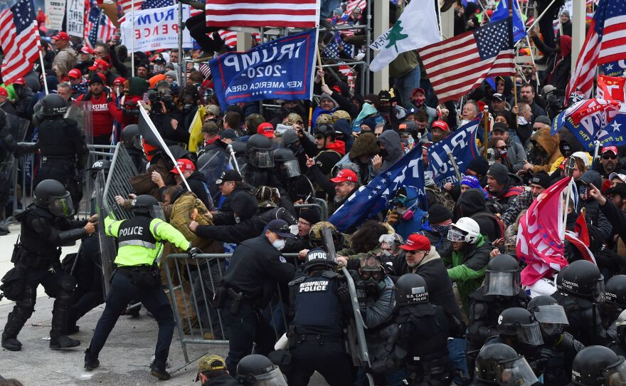 Trump supporters clash with police and security forces as they push barricades to storm the Capitol on Jan. 6, 2021.