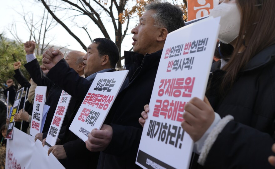 Members of civic groups shout slogans during a rally against the South Korean government's announcement of a plan over the issue of compensation for forced labors, in front of the Foreign Ministry in Seoul, South Korea, Monday, March 6, 2023.