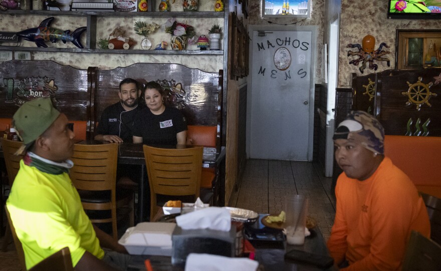 Ramiro Ruiz, chef and owner of 2 Sabores Mexican restaurant, poses for a photo with his wife at their restaurant in Fort Myers, Fla., in February.