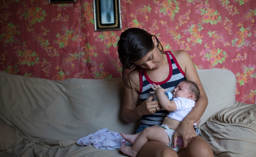 Angelica Pereira feeds her daughter Luiza, who was born with microcephaly, at her mother's house in Santa Cruz do Capibaribe, Brazil.