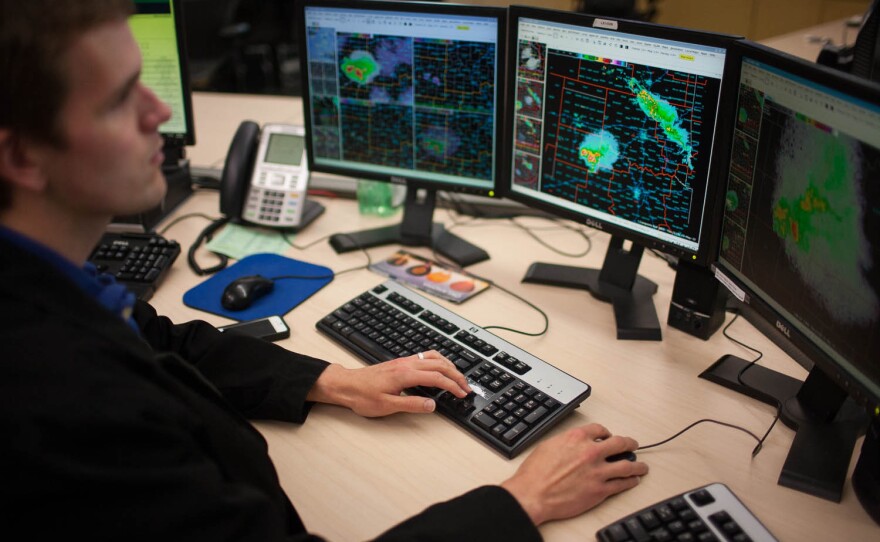 Marc Austin monitors radar and issues warnings at the National Weather Center in Norman, Okla., on Thursday.