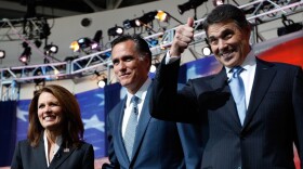 Texas Gov. Rick Perry (right) takes the stage with Mitt Romney and Rep. Michele Bachmann before Wednesday night's GOP presidential debate at the Ronald Reagan Presidential Library in Simi Valley,  Calif.