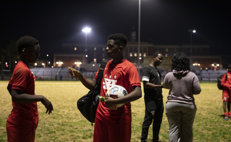 Joshua Nimley and Myko Idiokitis, from DCXI soccer team, pack up their gear after practice.