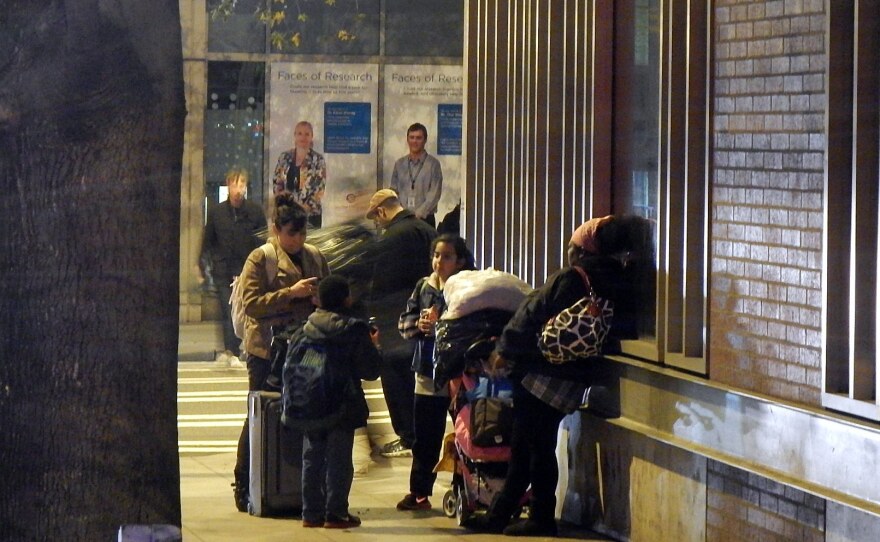 Homeless families on a sidewalk in downtown Seattle, outside Mary's Place shelter.