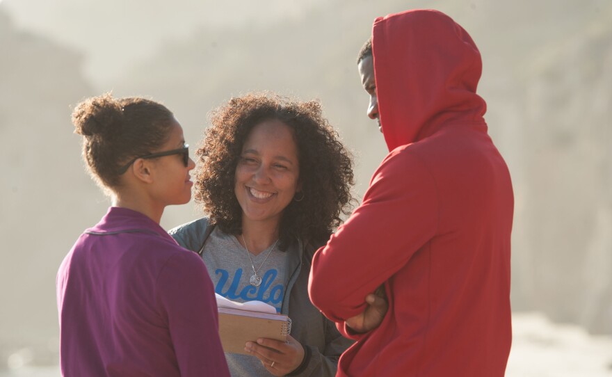 Director Gina Prince-Bythewood (center) works with Beyond The Lights stars Gugu Mbatha-Raw (left) and Nate Parker.