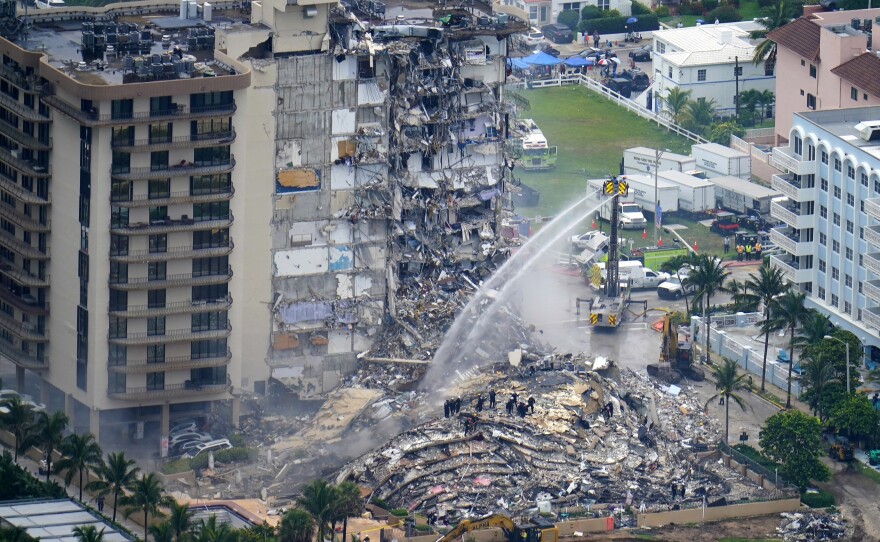 Rescue personnel work at the remains of the Champlain Towers South beachfront condo building in Surfside, Fla., after the June 2021 collapse that killed 98 people.