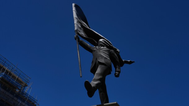 A statue of a man holding a flag covering his face, and signed 'Banksy', which has appeared in Waterloo Place in London, Thursday, April 30, 2026.