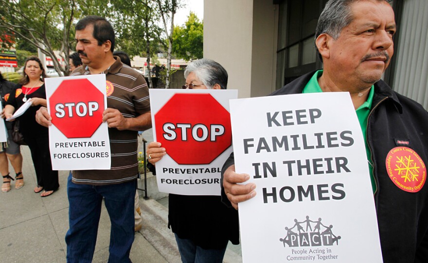 Demonstrators who have lost their homes to foreclosure or are under threat of foreclosure hold signs at a rally in front of JP Morgan Chase Bank in Oakland, Calif., last month.