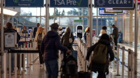 FILE - Travelers walk through a TSA security checkpoint at Reagan National Airport in Washington,  March 24, 2026.