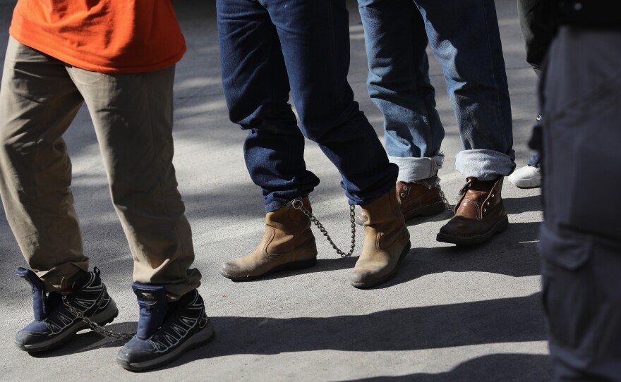 Unauthorized immigrants leave a court in shackles in McAllen, Texas. More than 40,000 immigration court hearings have been canceled since the government shut down.