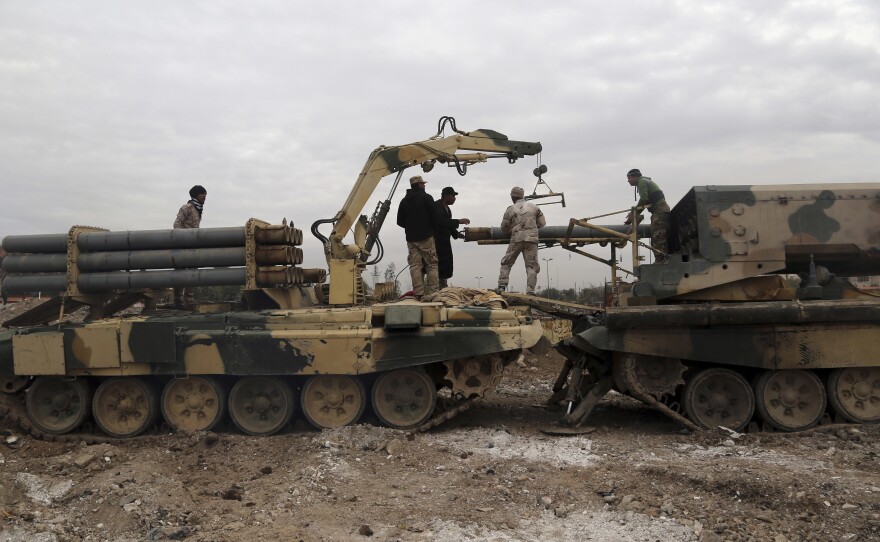 Iraqi soldiers load rockets into a rocket launcher on the eastern side of Mosul on Friday. The fighting in and around the city has been going on for the past four months, with the Iraqi forces slowly advancing.