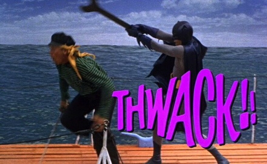 The "Batman" TV show was so popular that after its first season a movie was made starring Adam West and Burt Ward. Here West as Batman demonstrates his fight technique with some graphic support.