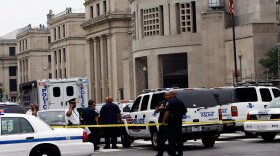 Police gather in front of the Holocaust Museum following a shooting at the museum June 10, 2009 in Washington, DC. According to reports, James van Brunn, 88, walked into the Holocaust Museum and exchanged fire with security guards, shooting one before being shot himself. 