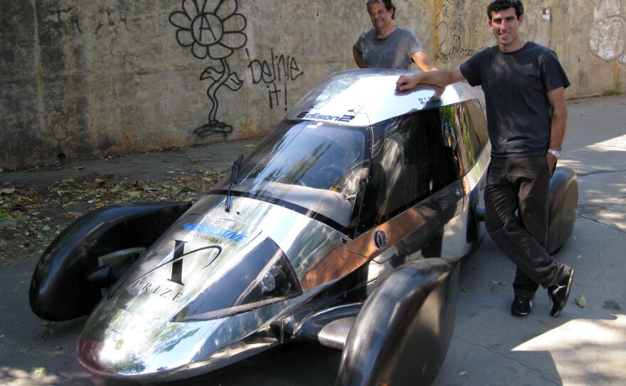 Team Edison2's Oliver Kuttner (left) and Brad Jaeger, one of the team's professional race car drivers, with the Very Light Car that won the mainstream class of the X Prize competition.