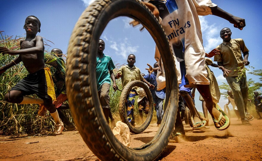Children play with tires outside a medical center in the West African nation of Togo.
