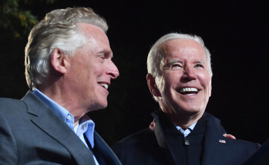 President Biden and Virginia Democratic gubernatorial candidate Terry McAuliffe stand on stage after a campaign event in Arlington, Va., on Oct. 26. Democrats are pulling in high profile party leaders to weigh in on the race.