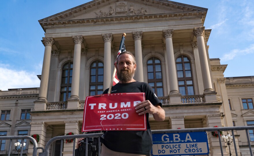 A supporter of President Trump's protests outside of the Georgia State Capitol Saturday in Atlanta. The president's campaign is requesting a recount in the state.