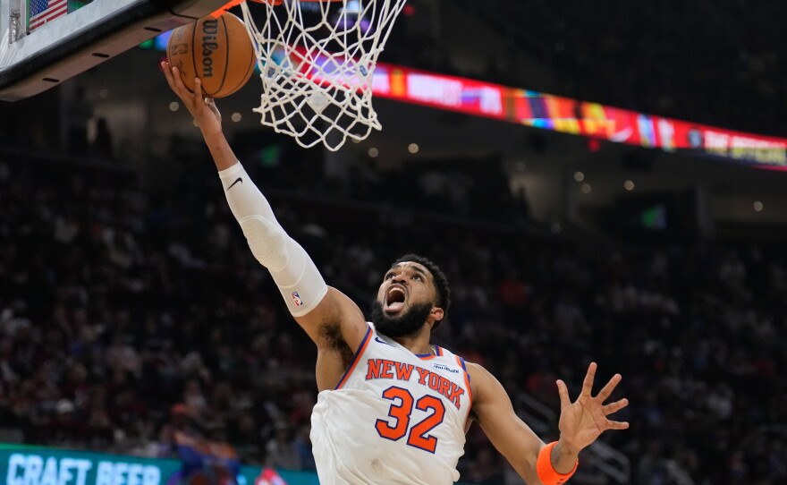 New York Knicks center Karl-Anthony Towns (32) shoots during the second half of Game 4 in the Eastern Conference finals NBA basketball playoffs series against the Cleveland Cavaliers in Cleveland, Monday, May 25, 2026.