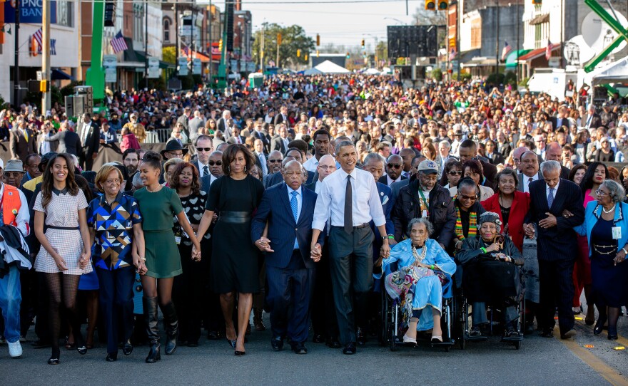 President Barack Obama, First Lady Michelle Obama and daughters Sasha and Malia and Rep. John Lewis prepare to walk across the Edmund Pettus Bridge to commemorate the 50th Anniversary of the Selma to Montgomery civil rights marches, in Selma, Alabama, March 7, 2015.