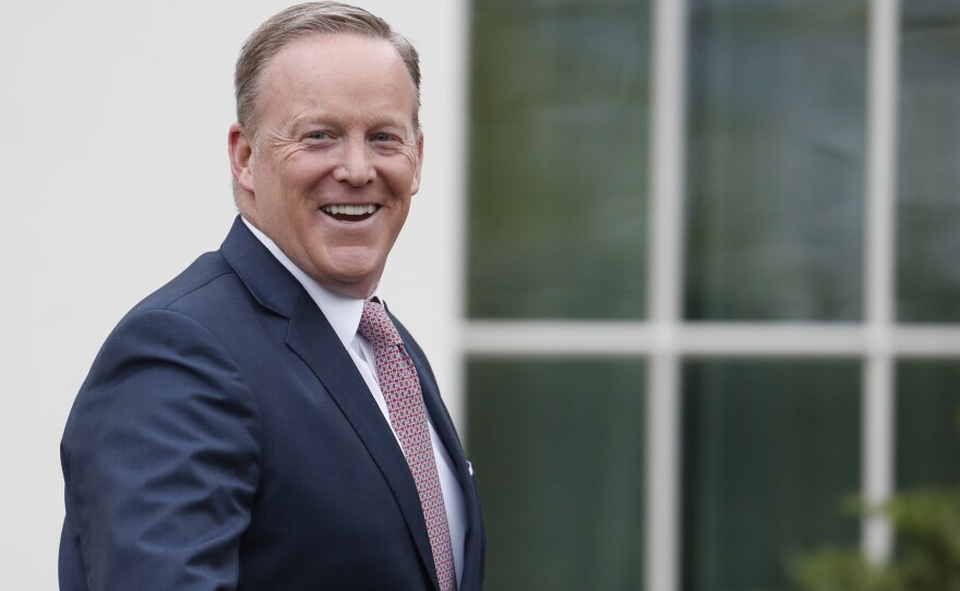 Outgoing White House press secretary Sean Spicer smiles as he departs the White House on July 21. Earlier that day Spicer resigned his position.