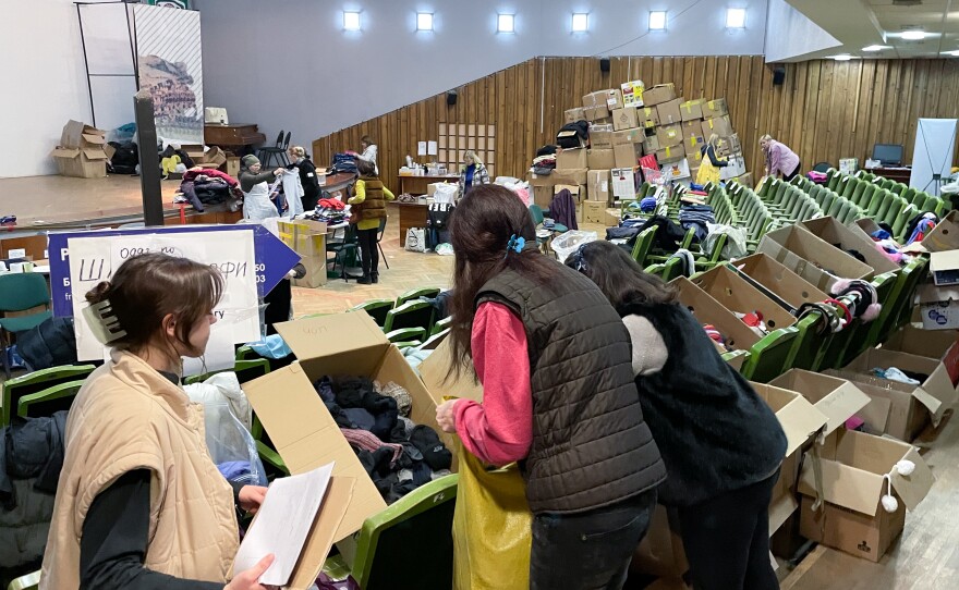 Women sort donated socks in a theater now being used as an aid distribution hub in downtown Lviv, Ukraine.