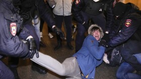 Police officers detain demonstrators in St. Petersburg, Russia on Thursday. Hundreds of people gathered in Moscow and St.Petersburg to protest against Russia's attack on Ukraine.