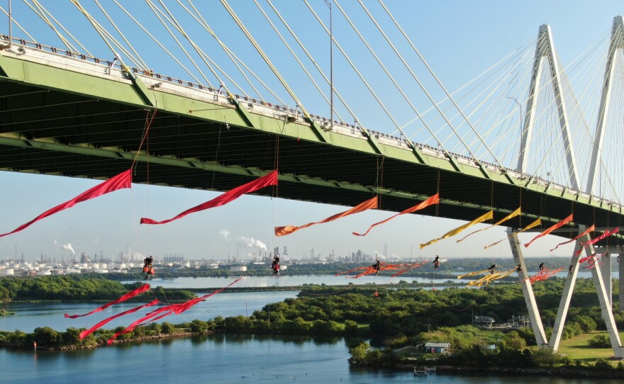 Greenpeace USA climbers rappelled off and formed a blockade on the Fred Hartman Bridge near Baytown, Texas, shutting down the Houston Ship Channel, the largest fossil fuel thoroughfare in the United States.