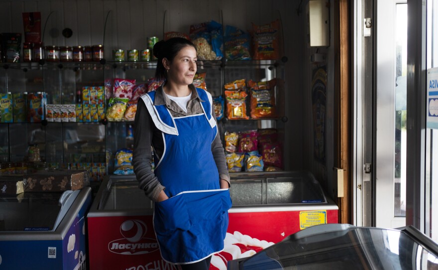 Oksana Zelenyuk works in the local mini-mart in Maksymivka, a village just across the Dnipro River from Russian-controlled areas. The villagers there are now separated from friends and family and have been unable to see them for months.