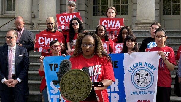 Interpreter Yves Valerus speaks at a LanguageLine press conference in front of New York City Hall in April. LanguageLine interpreters have had their hours drastically cut after the company said it experienced fewer customer demand and started using new scheduling software. Some workers are trying to organize a union.