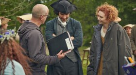 Aidan Turner as Ross Poldark and Eleanor Tomlinson as Damelza on set with the director.