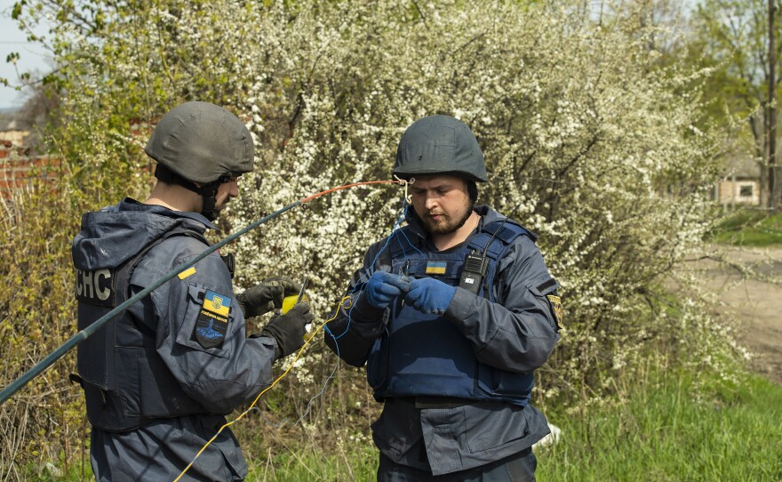 Kharkiv EOD technician Maksim affixes a C-4 charge to its firing point in preparation for detonating the first of the mines.