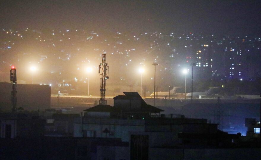 Planes are seen on the tarmac at the airport in Kabul late on August 30, 2021, hours ahead of the U.S. deadline to complete its frenzied withdrawal from Afghanistan.