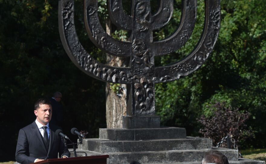 Ukrainian President Volodymyr Zelenskyy delivers a speech next to a menorah at The Babyn Yar Holocaust Memorial Center in Kyiv on Aug. 19, 2019.