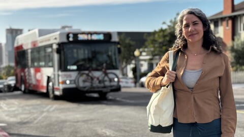 Monica De La Cruz stands in Golden Hill as an MTS bus passes behind her, March 2, 2026.