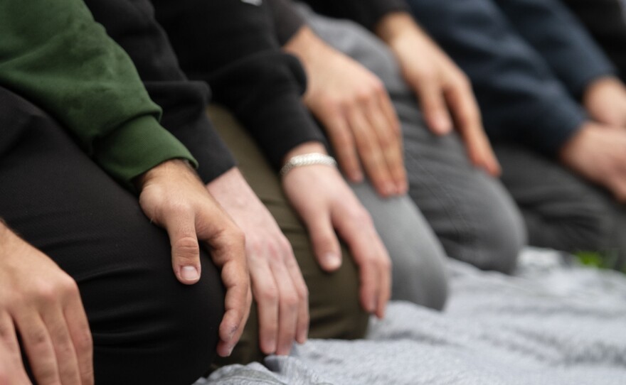 People sit in prayer at a protest for Gaza at UCSD in San Diego, Calif. March 6, 2024.