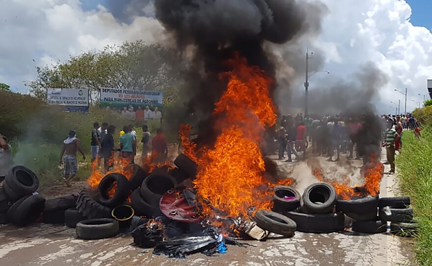 Residents of the Brazilian border town of Pacaraima burn tires and belongings of Venezuelan immigrants, after an attack on their makeshift camps.