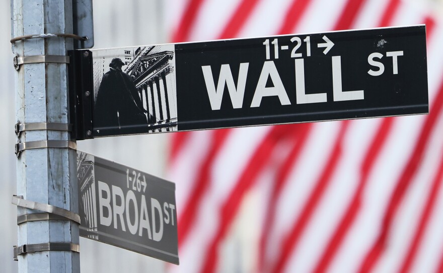 A Wall Street sign is seen outside of the New York Stock Exchange during morning trading on June 08, in New York City.