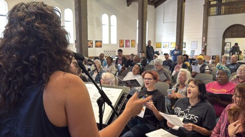 CEO Steph Johnson leading Voices of Our City choir in an original song in St. Paul's Episcopal Cathedral.
