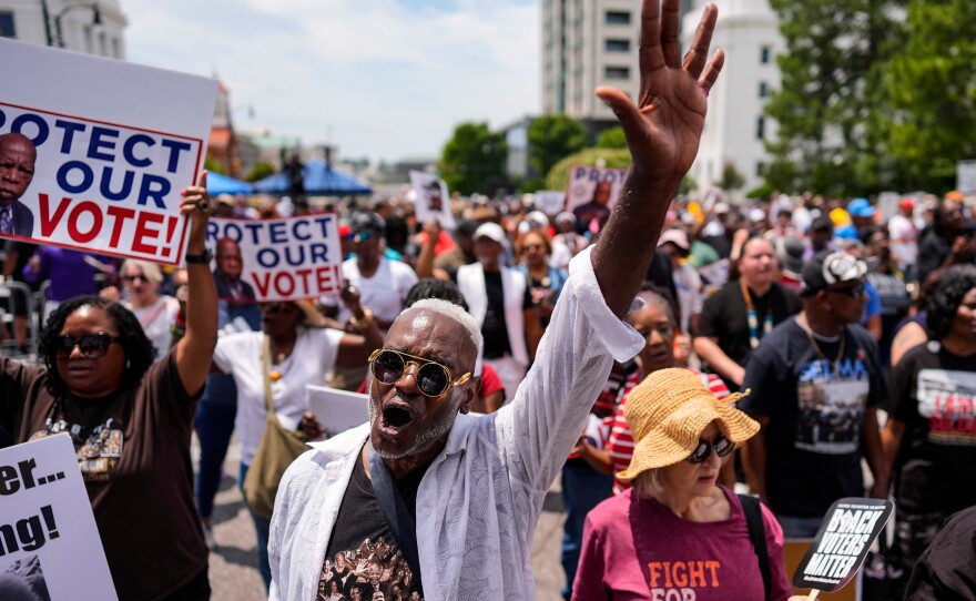 A man sings a spirtual song during a voting rally, Saturday, May 16, 2026, in Montgomery, Ala.