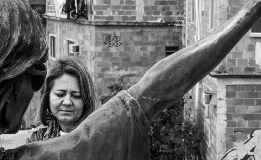 Salete Martins, a tour guide in the Santa Marta <em>favela,</em> stands in front of the Michael Jackson statue. She says tourists aren't coming because consulates told their citizens to stay away from <em>favelas.</em>