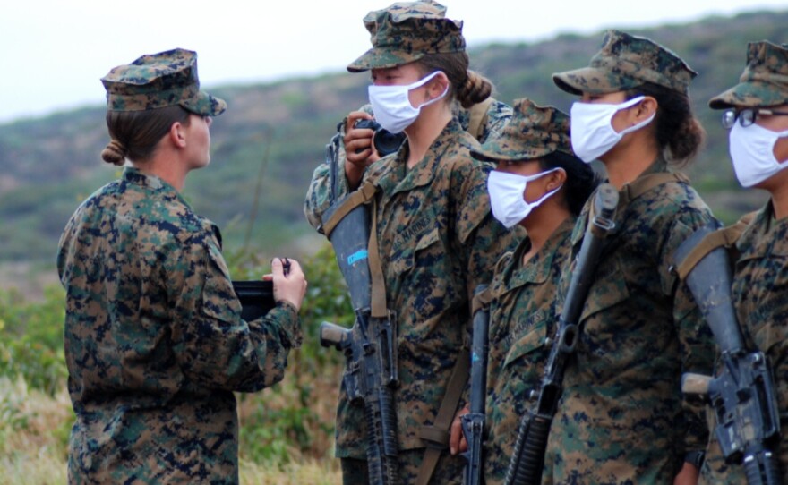 Senior drill instructor Staff Sgt. Amber Staroscik awarding the Eagle, Globe and Anchor pin to new Marines, April 22, 2021.