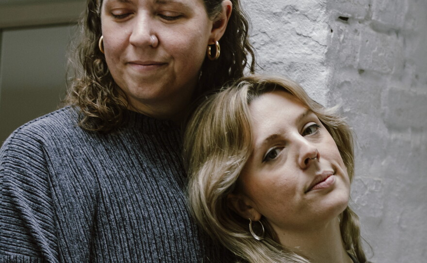 Lauren Wright, left, and Emma Brennan stand in their living room in Baltimore, Md.