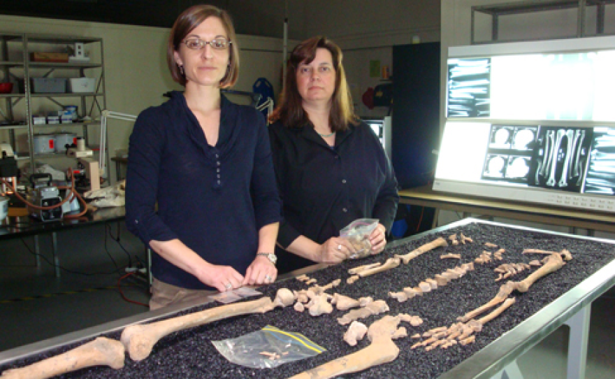 Kate Spradley, left, stands before the bones of a cadaver that's a subject of research in the Forensic Anthropology Center, Texas State University. Standing next to her is Michelle Hamilton. 