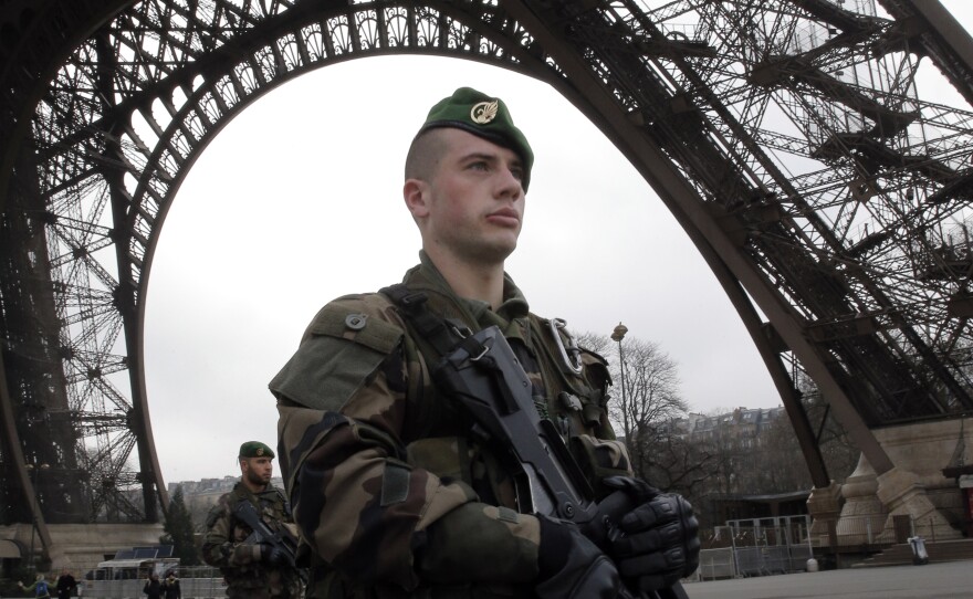 French soldiers patrol at the Eiffel Tower after a shooting at a French satirical newspaper, in Paris, France, Jan. 7, 2015.