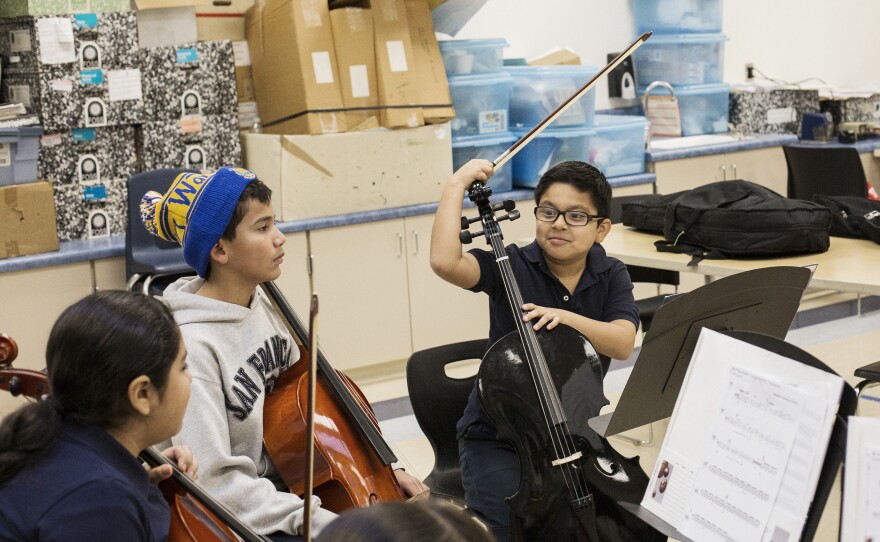 Carlos Garcia (right) chats with other students during the Sound Minds after-school program at Downer Elementary.