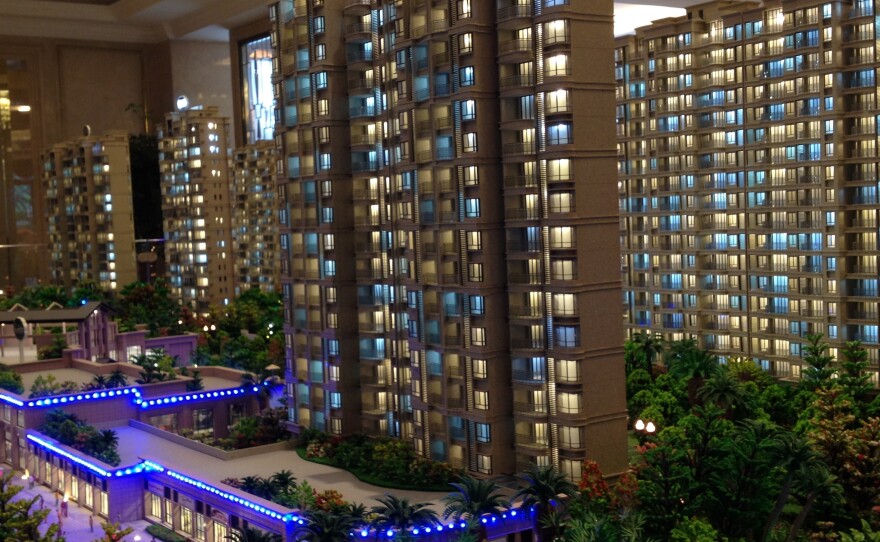 Real estate agents in Wuxi say construction continues in the city despite a lack of demand. Here, models of new apartment buildings are on display at a local sales office.