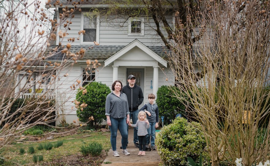 Maryanne Rawlings and her husband, Rob Rawlings, stand with their children, Jane, 3, and Robert, 7, at their home in Wyncote, Penn., on March 30. Both parents are teachers and have been working remotely. They are trying to balance teaching with helping Robert with schoolwork and keeping Jane entertained.