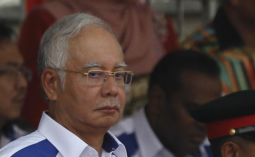 Malaysian Prime Minister Najib Razak waves the Malaysian flag during National Day celebrations on Aug. 31, 2015. He has faced widespread criticism and protests over allegations that huge sums disappeared from a government-owned investment fund.